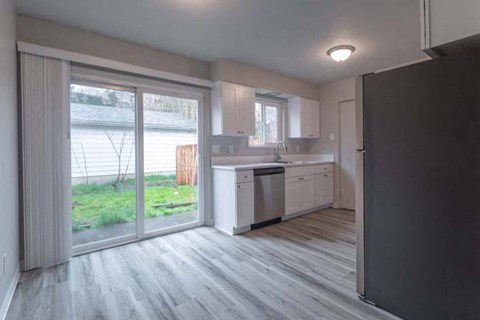 an empty kitchen with a sliding glass door